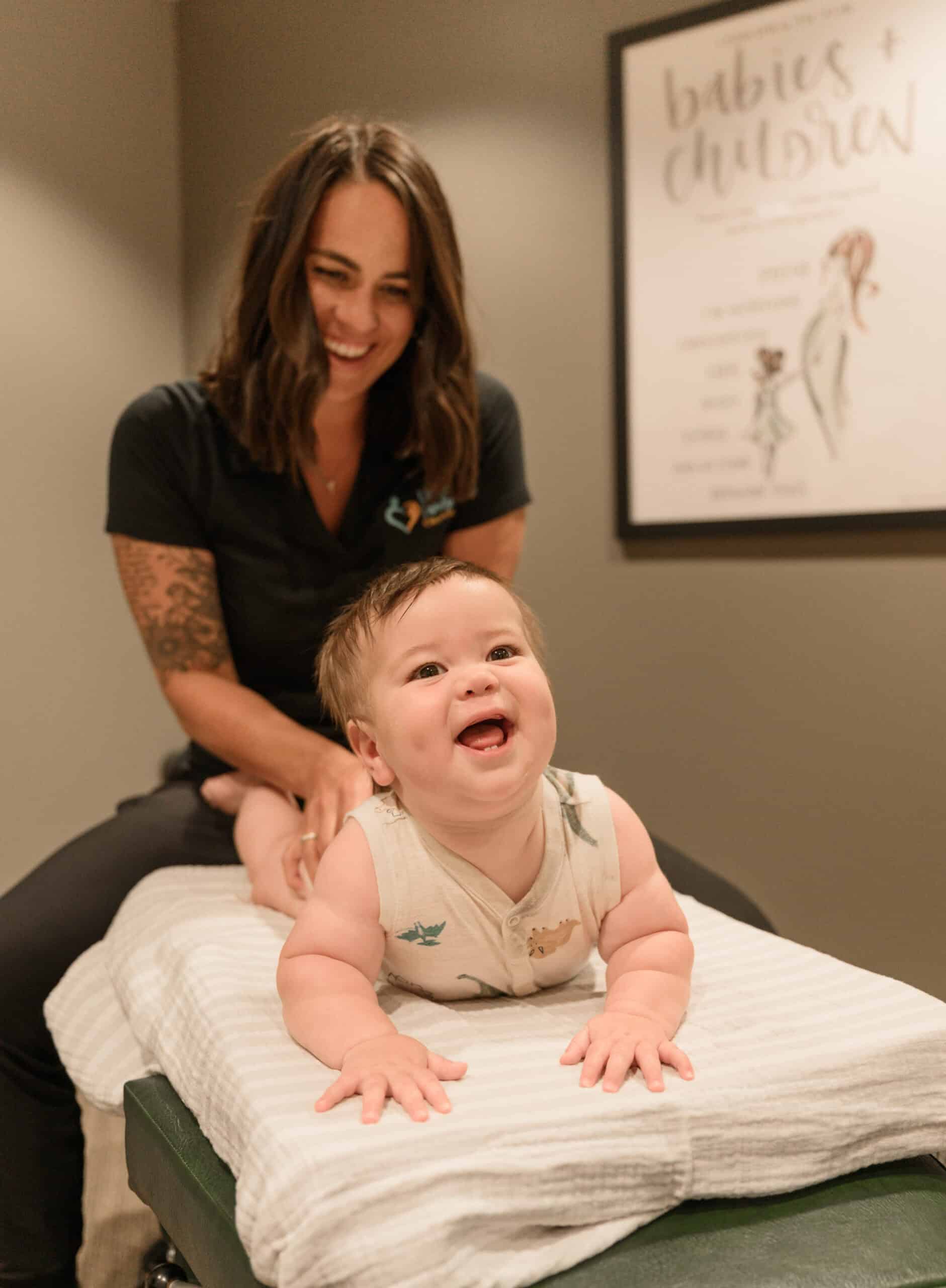 Children's chiropractic care with a smiling young patient during a treatment session at Lincoln Family Chiropractic. Friendly environment specializing in pediatric chiropractic and family wellness.