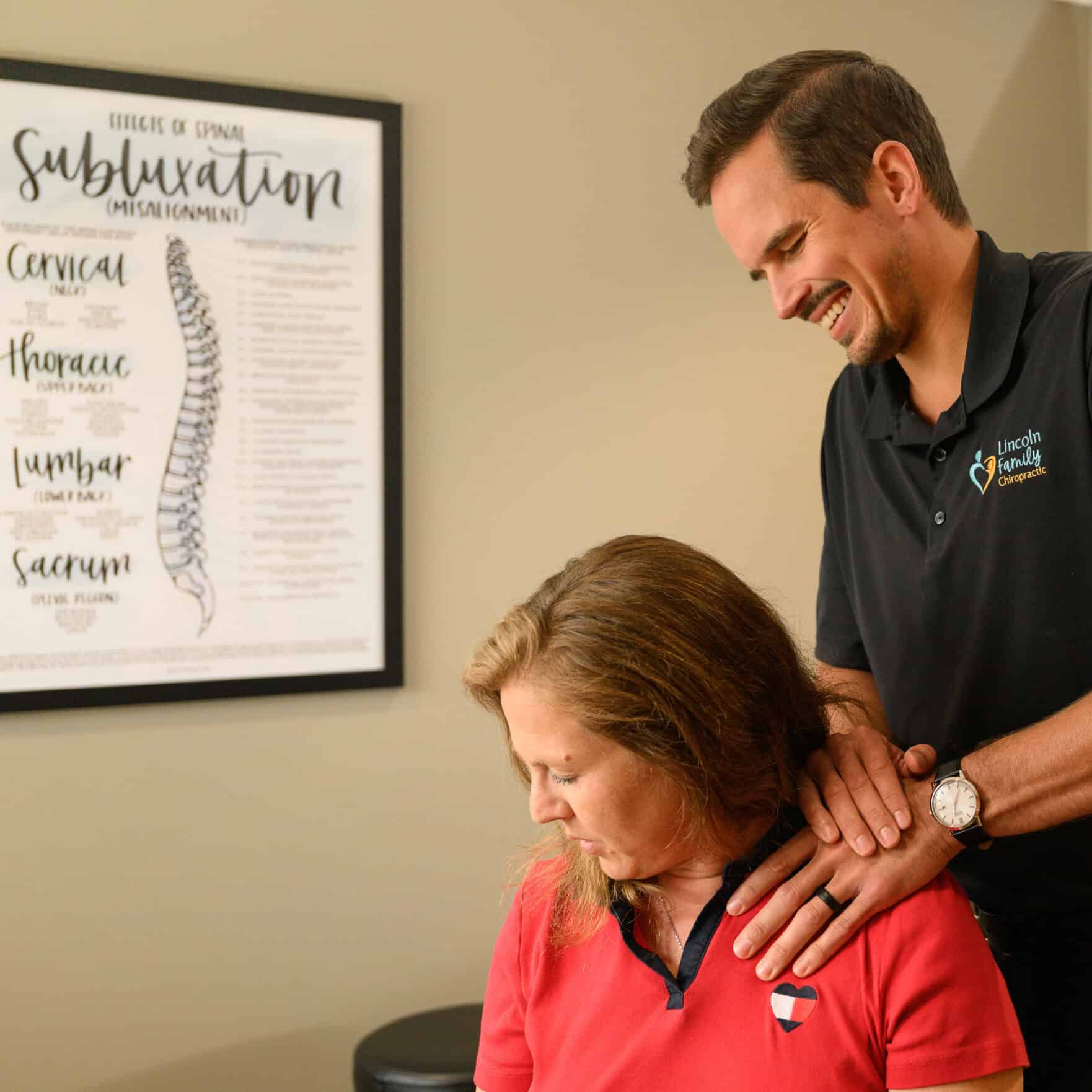 Chiropractic adjustment being performed on a woman at Lincoln Family Chiropractic for neck and shoulder pain relief and spinal health.
